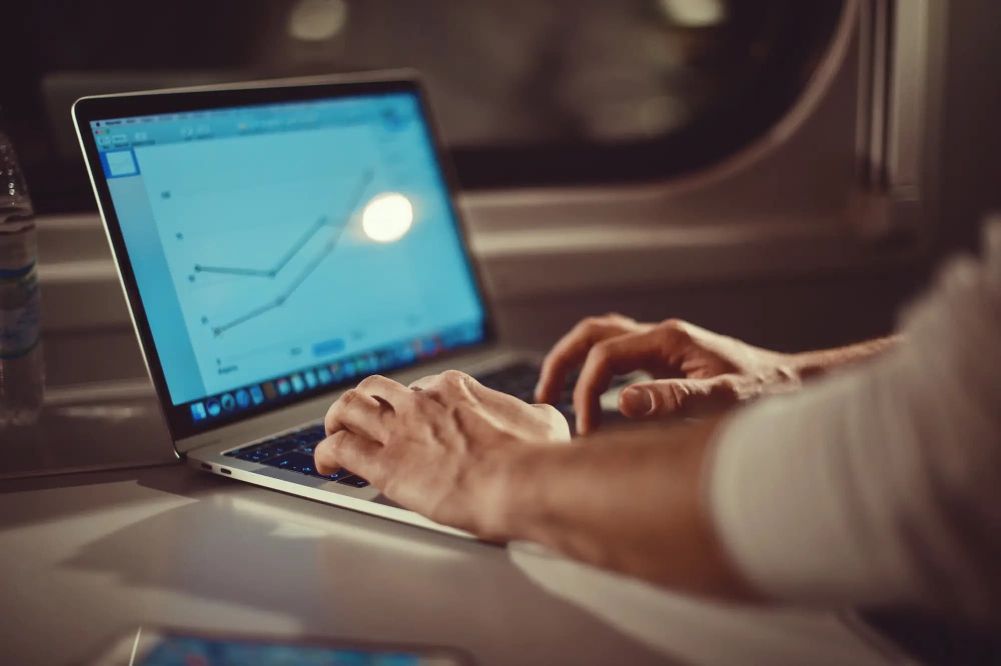 Developer analyzing application performance metrics on a laptop during enterprise application migration to modern cloud infrastructure.
