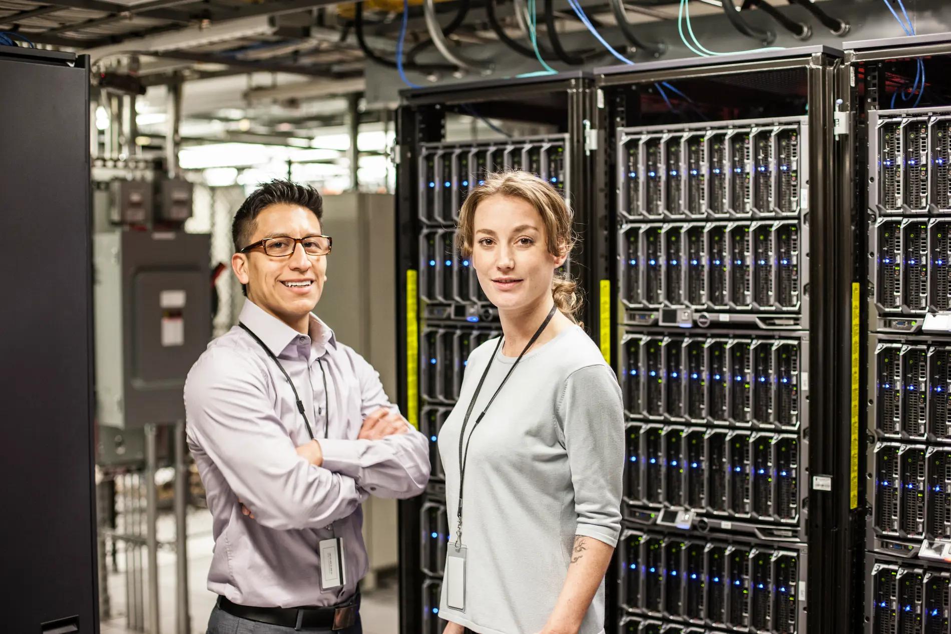caucasian-man-and-woman-technicians-in-a-large-computer-room