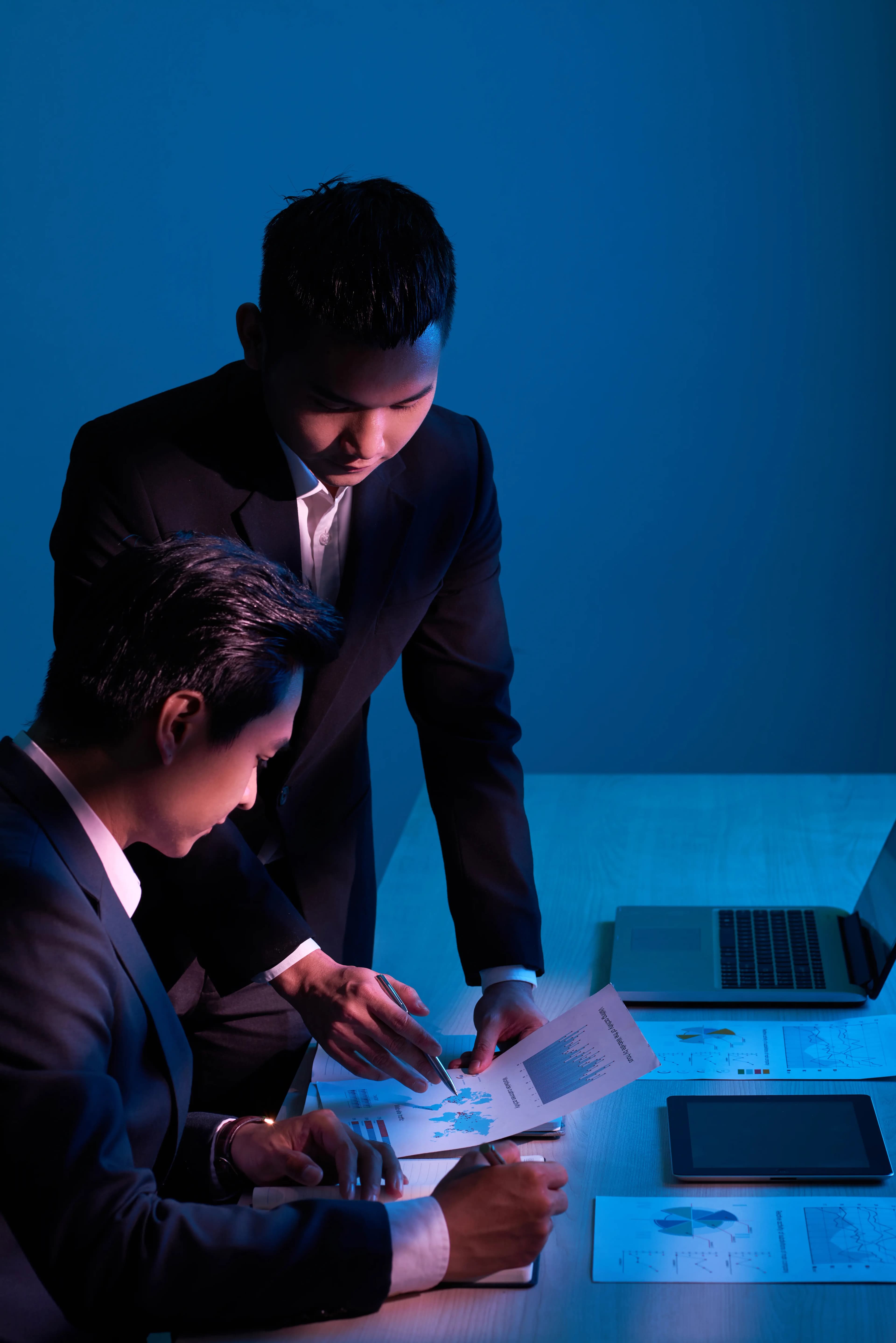 Engineers analyzing system architecture and data reports to assess legacy systems and plan AI-driven modernization strategies for scalable cloud-native platforms.