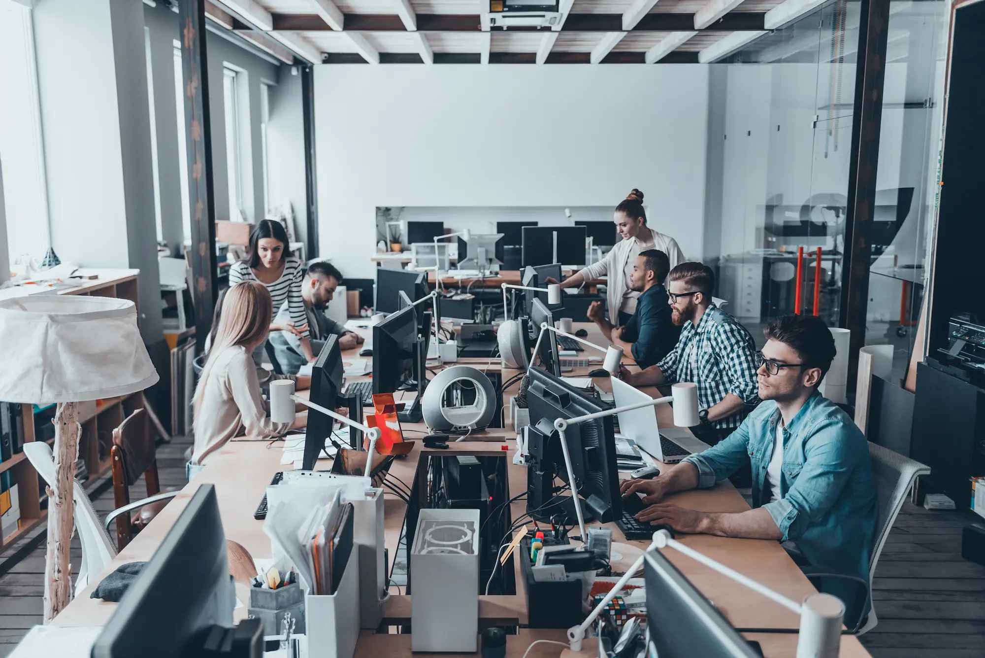 Software engineers collaborating in a modern development office, building enterprise applications and AI-powered solutions with ELCA, Swiss software engineering partner.